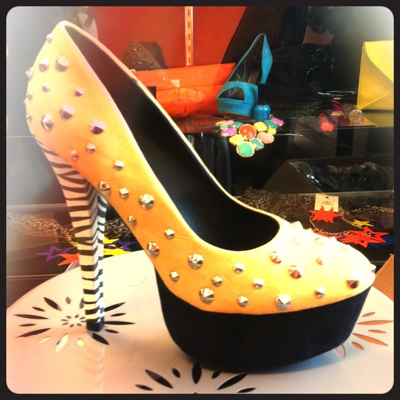 Yellow, black, and silver spike heel