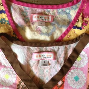 2 Koi Scrub Tops. A blue top. Pink scrub pants.
