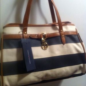 Leather straps on purse with gold anchor charm