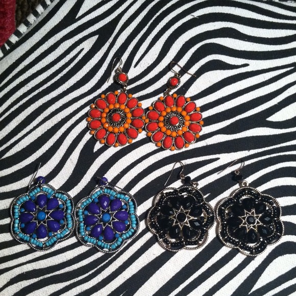 Three pairs of earrings .