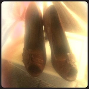 Brown heels with flower embellishment.