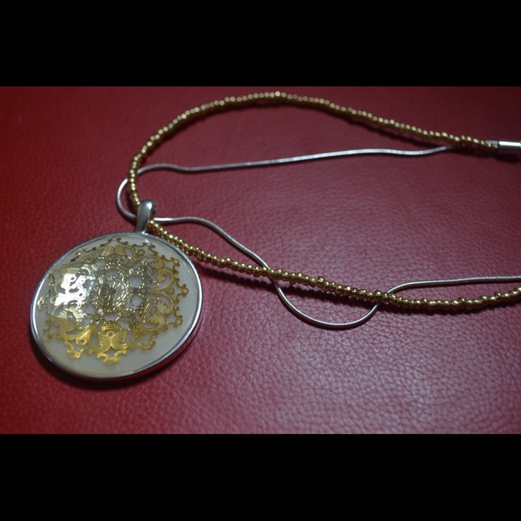 Detailed gold pendant
