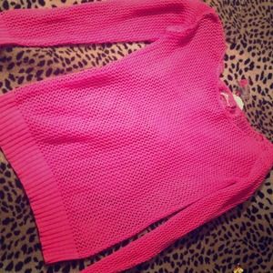 Pink loosely knitted sweater.