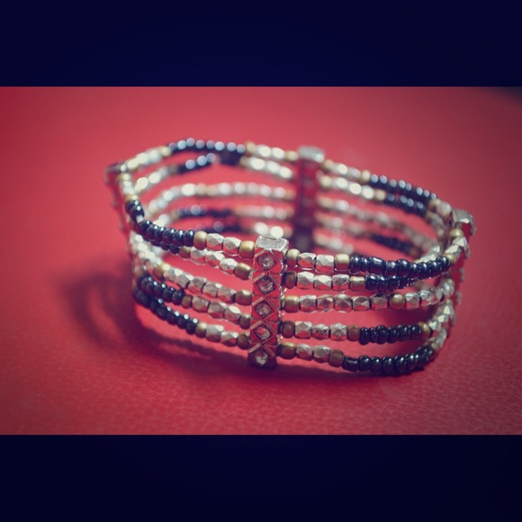 Black, silver and gold tone bracelet