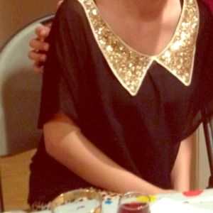 Black loose top with gold sequined collar. ON HOLD