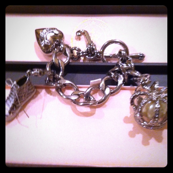 Juicy Couture authentic bracelet with 2 charms .
