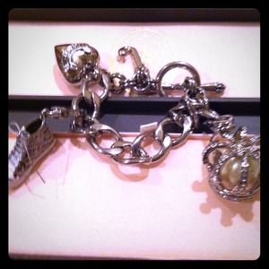 Juicy Couture authentic bracelet with 2 charms .