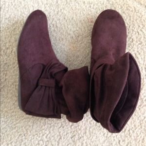 Brown, low top suede boots. Bow on the side