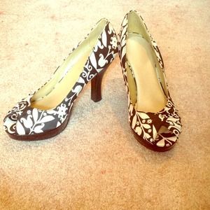 A pair of black and white designer heels