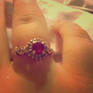 10k Gold Ruby ring with diamonds around it