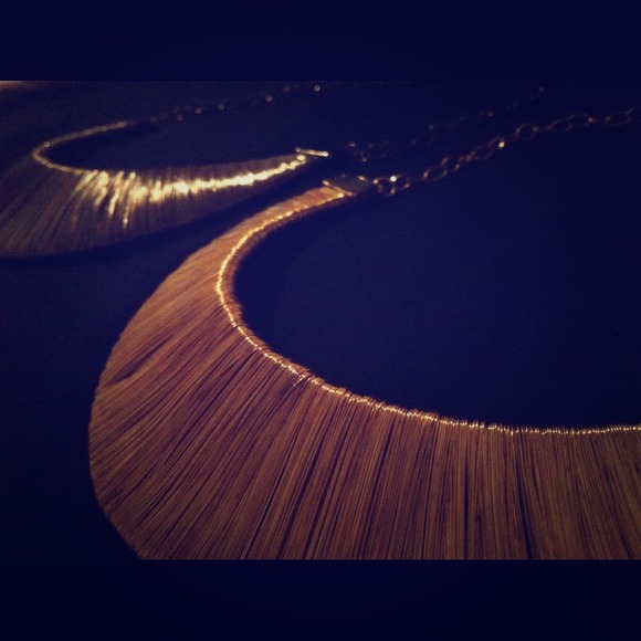 Two necklaces one gold one a vintage dark gray
