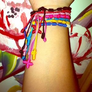 Hand made cloth bracelets with hanging cross.