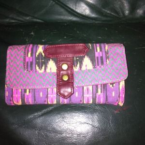 A pink and multi color wallet never used