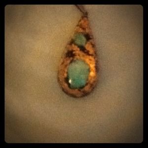 Gold pendant with teal accent