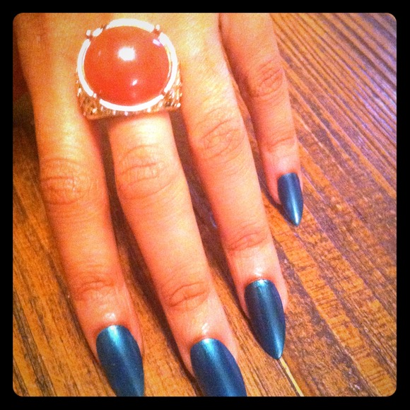 Gold ring with red rounded face.
