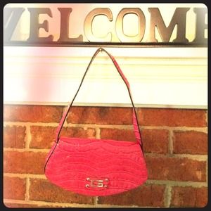 Fuchsia Guess clutch with small strap.