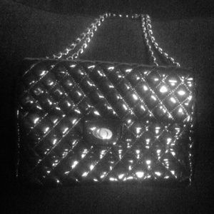 Shiny black quilted chain purse.