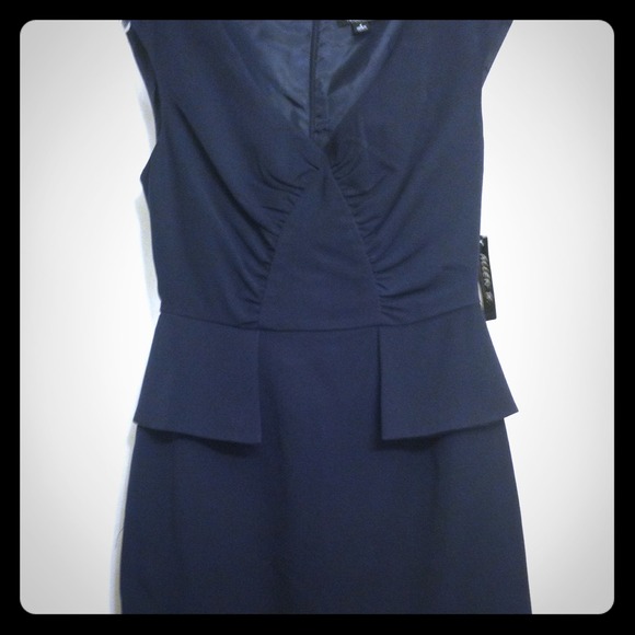 Navy blue cinches waistline. Very feminine