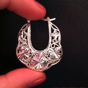 Big fashionable silver earrings.. Not real silver.