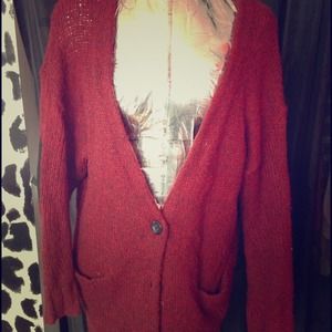 red sweater with a black shoulder patch