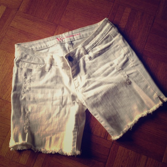 Distressed white jean shorts