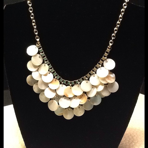 Off white necklace. Looks like shells but is not.