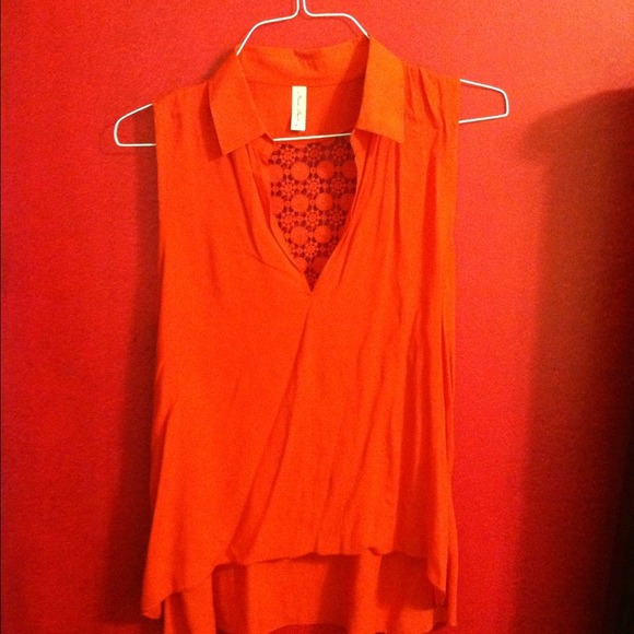 Red v neck top with design on back.