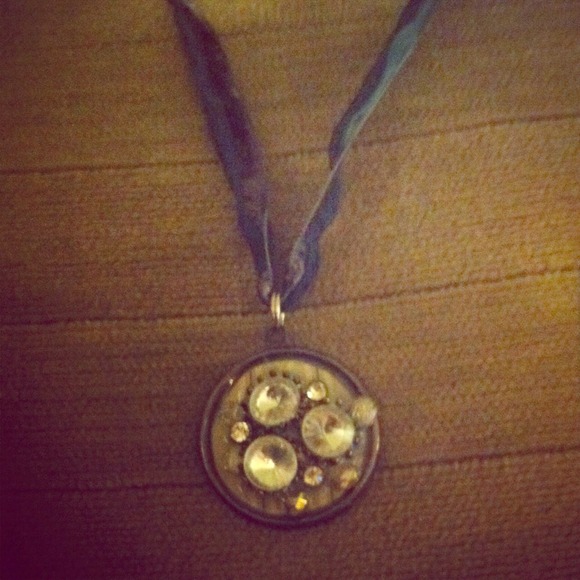 Handmade round pendant with vintage rhinestones.