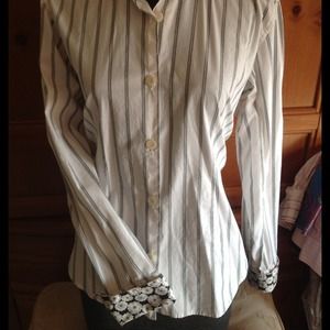 Striped button down blouse with contrast cuffs.
