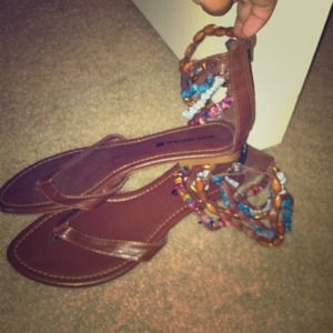 Dark tan beaded sandals.