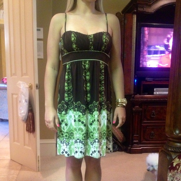 Dress in brown, cream & green with a tie in back.
