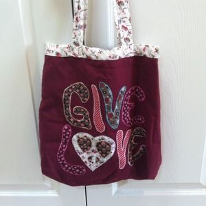 Maroon purse that says 'Give Love'
