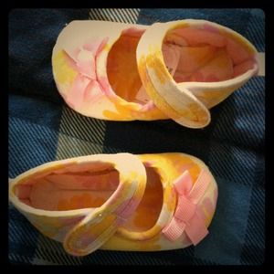 Yellow and pink newborn shoes