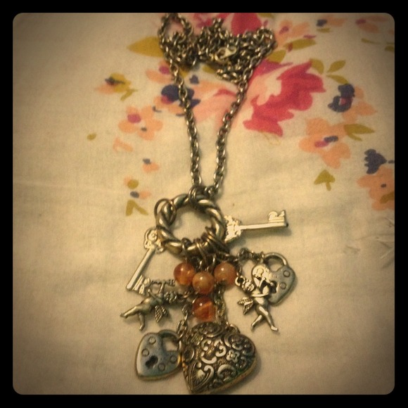 Long necklace with charms .