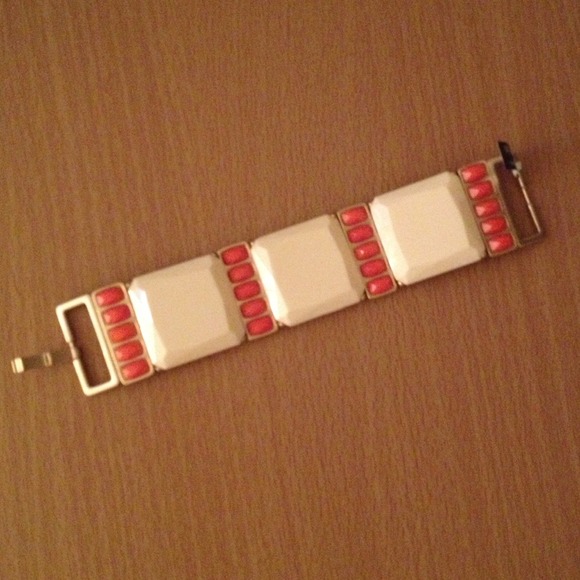 Bracelet with cream and orange/coral accents.