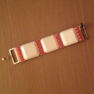 Bracelet with cream and orange/coral accents.