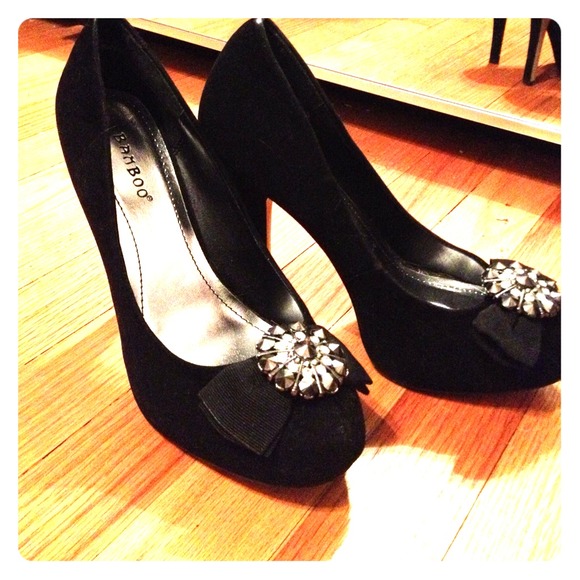 Black suede pump with rhinestone embellishment.