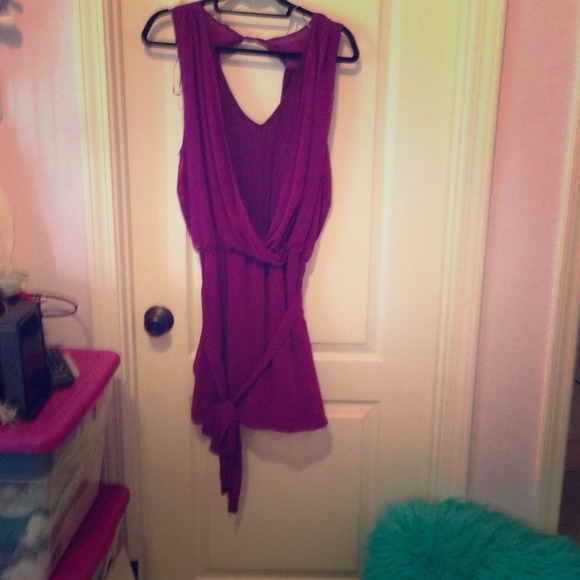 A purple bodycon type dress with sheer overlay.