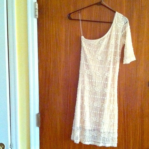 Cream colored one shoulder lace dress.