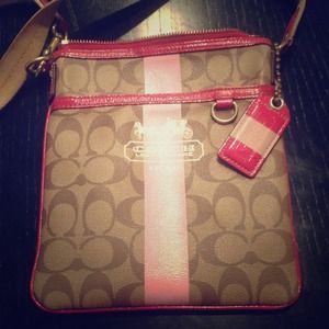 Coach cross body purse with pink accent color