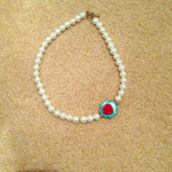 Pearl necklace with turquoise cross and red rose