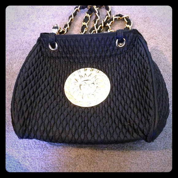 Black handbag with gold sun plate