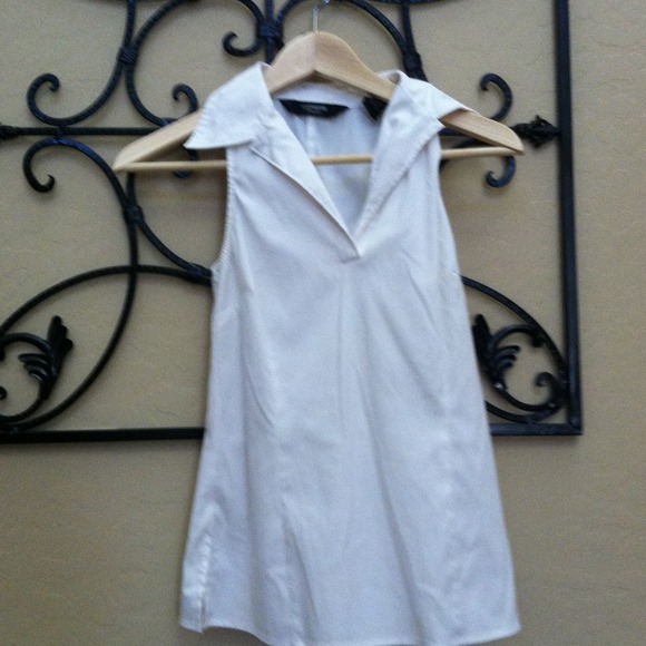 A cute sleeveless white collared shirt