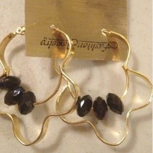 Unique gold earrings with black accent beads.