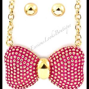 Embellished bow necklace with stud earrings.