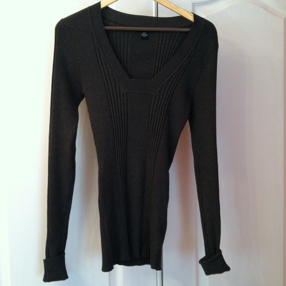 Dark gray sweater/shirt with cuffs at wrists.