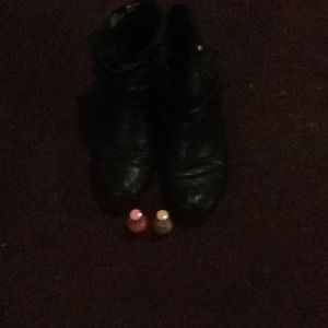 Two nail polishes a pair of black boots