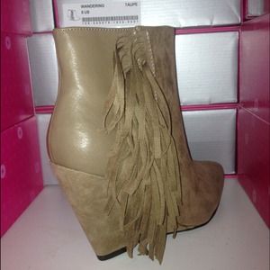Tan leather and suede fringe boot.