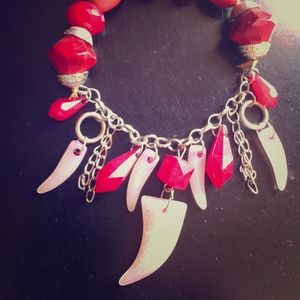 Funky redish bracelet with dangling horns