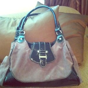 Beautiful grayish purse with black shinny trim.